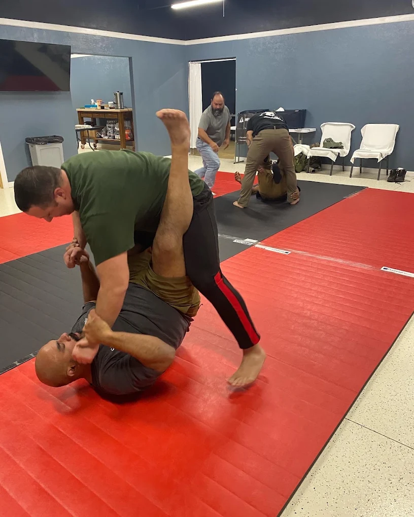 Students practicing Brazilian Jiu-Jitsu on the mats