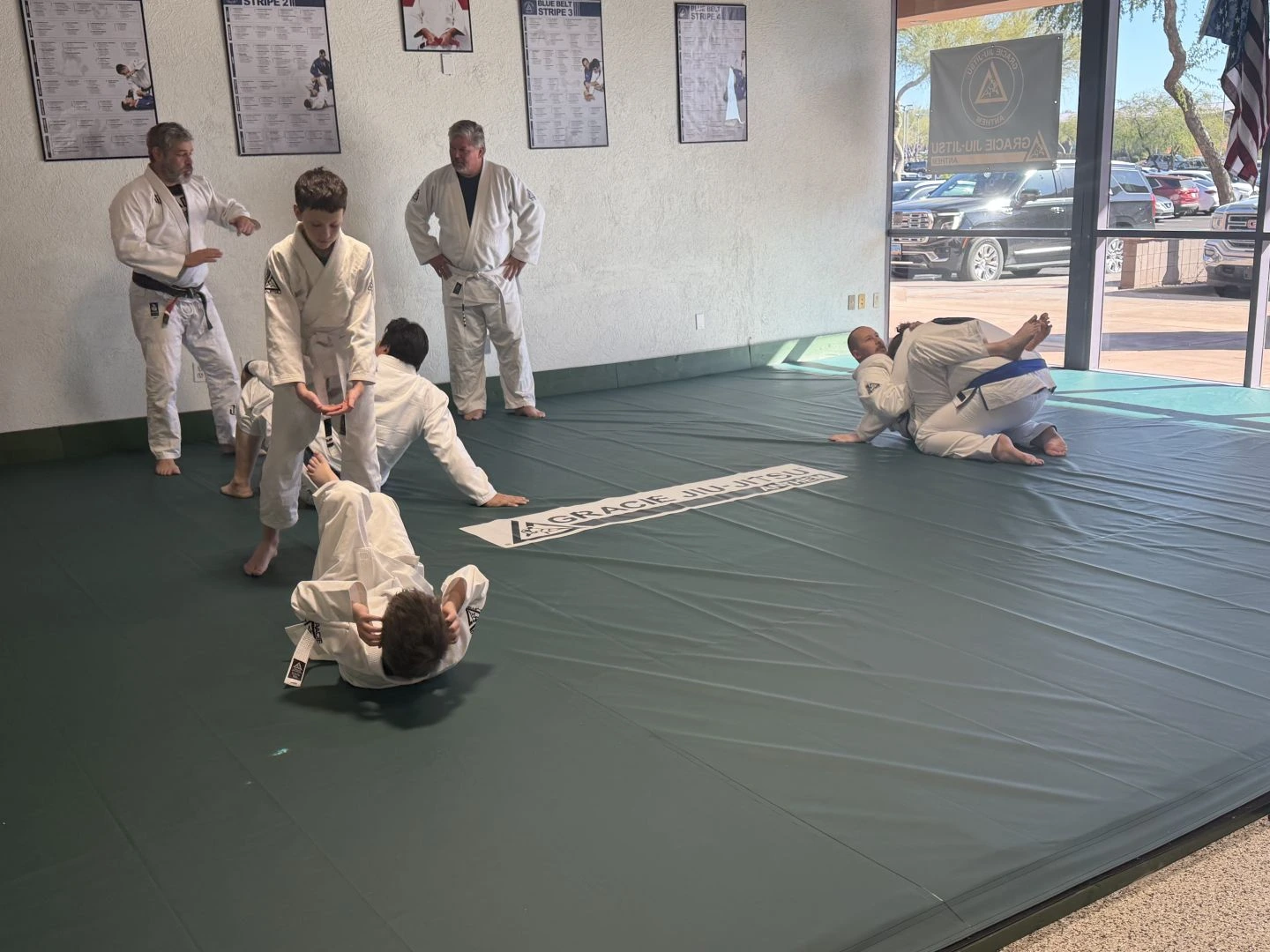 Kids and instructors training together on the mats