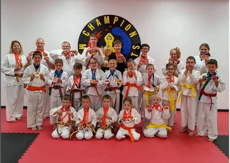 Champion Martial Arts students posing with medals