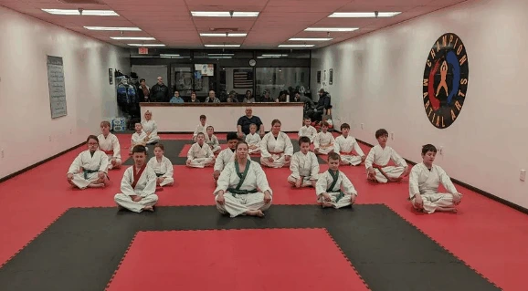 Students seated on the mat at Champion Martial Arts