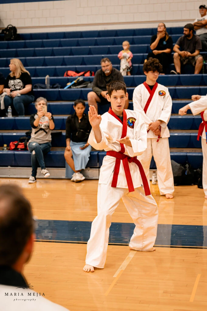 Student performing a martial arts form during a tournament