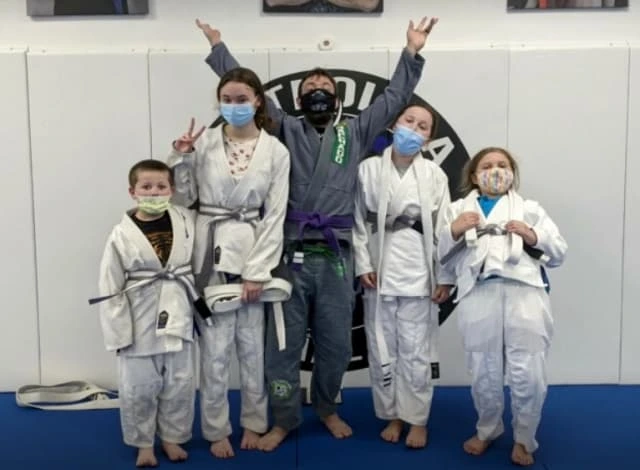 Student group in martial arts uniforms on the mat