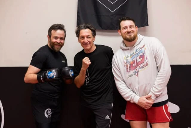 Students and coaches posing together at Metrolina Martial Arts
