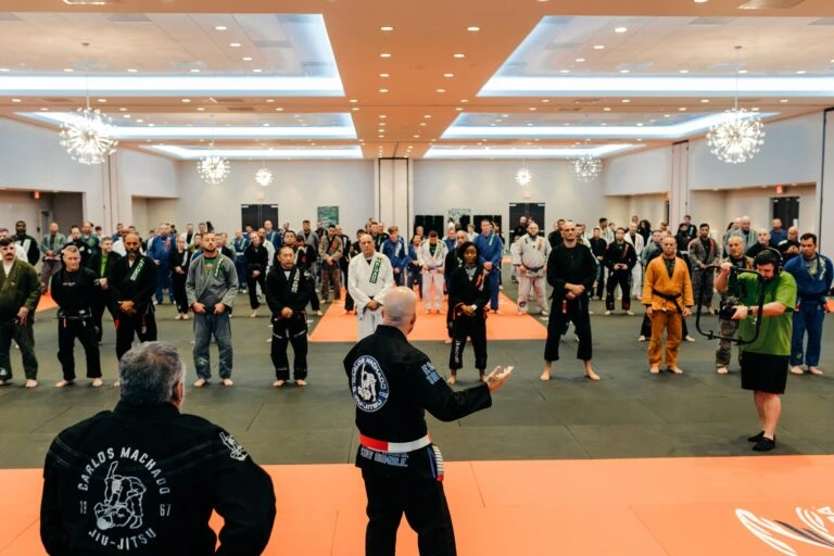 Large martial arts seminar with students on the mat