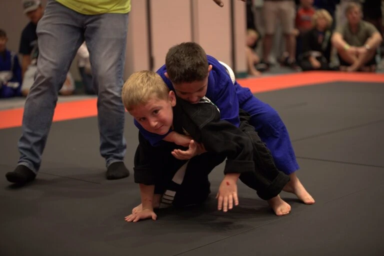 Two kids grappling during a martial arts match
